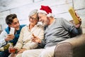 Happy family giving gifts and sharing fun and laughs together each other in holiday christmas celebration at home -grandfathers