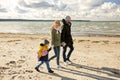 Happy family going to picnic on beach in autumn Royalty Free Stock Photo