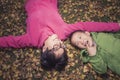 Happy family lying on golden leaves background Royalty Free Stock Photo