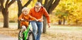 Happy family grandfather teaches child grandson  to ride a bike in park Royalty Free Stock Photo