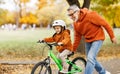 Happy family grandfather teaches child grandson  to ride a bike in park Royalty Free Stock Photo