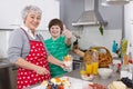 Happy family: Grandmother and grandson cooking together. Royalty Free Stock Photo