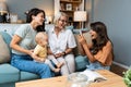 Happy family. Grandmother, mother, aunt and little baby having fun at home. Relatives visiting new born child Royalty Free Stock Photo