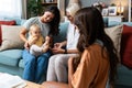 Happy family. Grandmother, mother, aunt and little baby having fun at home. Relatives visiting new born child Royalty Free Stock Photo