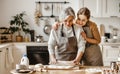 Happy family grandmother  old mother mother-in-law and daughter-in-law daughter cook in kitchen, knead dough, bake cookies Royalty Free Stock Photo