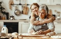 Happy family grandmother old mother mother-in-law and daughter-in-law daughter cook in kitchen, knead dough, bake cookies