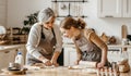 Happy family grandmother  old mother mother-in-law and daughter-in-law daughter cook in kitchen, knead dough, bake cookies Royalty Free Stock Photo
