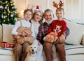 Happy family grandparents, grandchildren and dog golden retriever during Christmas holidays at home Royalty Free Stock Photo