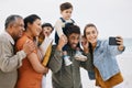 Happy family, grandparents and selfie on beach for kids holiday, vacation and outdoor on social media. Mother, father Royalty Free Stock Photo