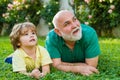 Happy family Grandson hugs his grandpa on holiday. Two generation - weekend together. Grandson embrace his grandfather Royalty Free Stock Photo