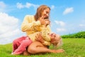 Mother tickling funny baby son lying on her laps Royalty Free Stock Photo