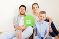 Happy family with green house moving to new home Royalty Free Stock Photo