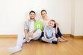 Happy family with green house moving to new home Royalty Free Stock Photo