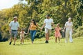 Happy family, hand holding and nature park walk with mom, dad and children with grandparents. Walking mother, kids and Royalty Free Stock Photo