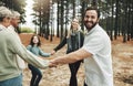 Happy family, hands and dance in forest with girl, parents and grandparents dancing in a circle in nature. Family, kids