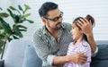 Happy family handsome Asian father, little daughter girl sitting on sofa in cozy living room at home, doing activity together, Royalty Free Stock Photo