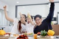 Happy family has meal in dining room. Mother father kid daughter sit at dining table, have fun during breakfast or lunch. Cheerful Royalty Free Stock Photo