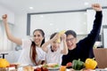 Happy family has meal in dining room. Mother father kid daughter sit at dining table, have fun during breakfast or lunch. Cheerful Royalty Free Stock Photo