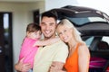 Happy family with hatchback car at home parking Royalty Free Stock Photo