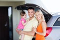 Happy family with hatchback car at home parking Royalty Free Stock Photo