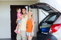 Happy family with hatchback car at home parking Royalty Free Stock Photo