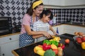 Happy Family have Dad, Mom and their little daughter Cooking Together in the Kitchen Royalty Free Stock Photo