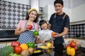 Happy Family have Dad, Mom and their little daughter Cooking Together in the Kitchen Royalty Free Stock Photo