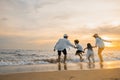 Happy family have fun jumping on beach in holiday at sunset Royalty Free Stock Photo