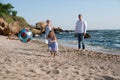 Happy family have a rest playing ball near sea Royalty Free Stock Photo