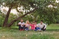 Happy Family have a rest under tree apple Royalty Free Stock Photo