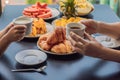 Happy family having breakfast on the balcony. Breakfast table with coffee fruit and bread croisant on a balcony against the backdr