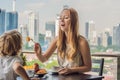 Happy family having breakfast on the balcony. Breakfast table with coffee fruit and bread croisant on a balcony against Royalty Free Stock Photo