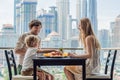 Happy family having breakfast on the balcony. Breakfast table with coffee fruit and bread croisant on a balcony against