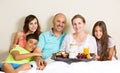 Happy family having breakfast in bed Royalty Free Stock Photo