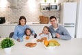 Happy family having breakfast at home. Having healthy breakfast on modern stylish kitchen Royalty Free Stock Photo