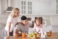 Happy family having breakfast together at table in modern kitchen Royalty Free Stock Photo