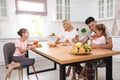 Happy family having breakfast together at table in modern kitchen Royalty Free Stock Photo