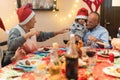 Happy family having dinner at home in christmas - Grandfather holding his grandson - Holiday and togetherness - Joyful and new Royalty Free Stock Photo