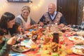 Happy family having dinner at home in christmas - Grandmother laughing with his granddaughter - Holiday and togetherness - Joyful