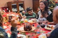 Happy family having dinner at home in christmas - Mother holding his daughter - Holiday and togetherness - Joyful and new year Royalty Free Stock Photo