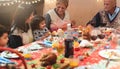 Happy family having dinner at home - holiday and togetherness near xmas tree - Focus on grandfather - joyful christmas eve Royalty Free Stock Photo