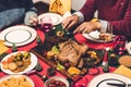 Happy family are having dinner with tasty baked roasted whole fried chicken and wine glasses with christmas decoration on the Royalty Free Stock Photo