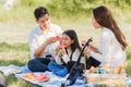 Happy family having enjoying outdoor sitting on picnic blanket eating watermelon in park sunny time Royalty Free Stock Photo