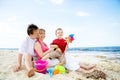 Happy family having fun on the beach. Royalty Free Stock Photo