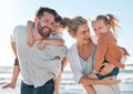 Happy family having fun at the beach. Portrait of smiling parents with children playing and laughing during a summer Royalty Free Stock Photo