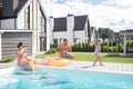 Happy family having fun while chilling near swimming pool Royalty Free Stock Photo