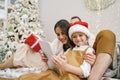 Happy family having fun on digital tablet in bed on Christmas Royalty Free Stock Photo