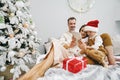 Happy family having fun on digital tablet in bed on Christmas Royalty Free Stock Photo