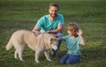 Happy family is having fun with dog husky. Happy father and his son playing with dog in park. Royalty Free Stock Photo