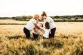 Happy family having fun in the field. Concept of a joyful and united family